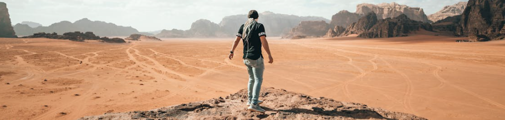 Traveler exploring rocky arid terrain during vacation وادي رم