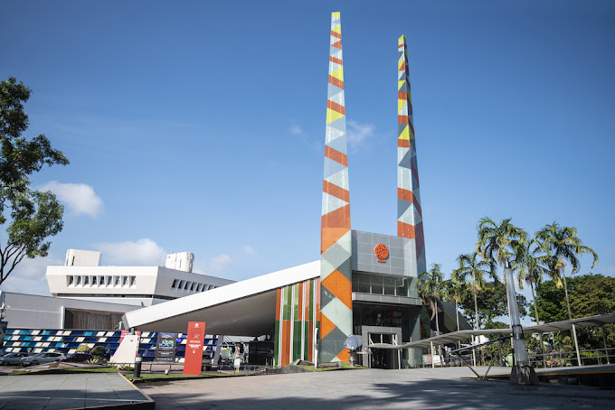 Front entrance of Science Centre Singapore with visitors on a sunny day