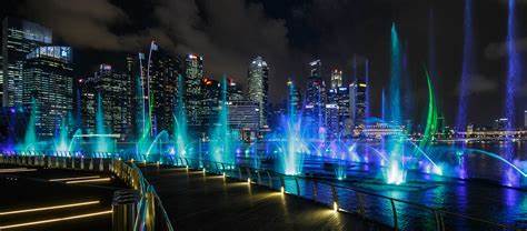Spectra Marina Bay viewed from Merlion Park with reflections across the bay