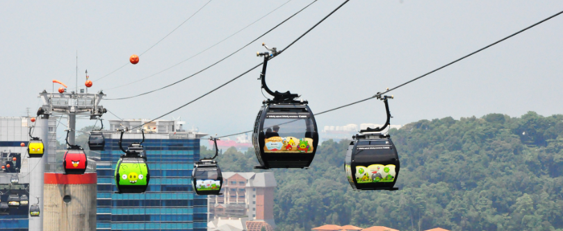 singapore Cable car cabin gliding over Keppel Harbour towards Sentosa at sunset
